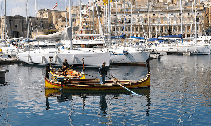 Best Things To Do in Malta | A dgħajsa boatman awaits passengers in Malta's Grand Harbor